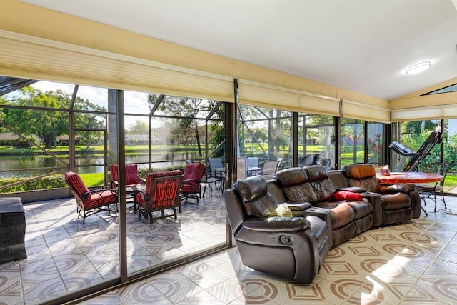 sunroom featuring lofted ceiling and a water view