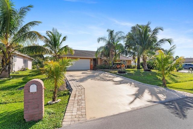 view of front of home featuring a garage, driveway, and a front yard