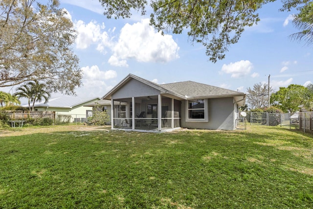 back of house featuring a fenced backyard, a shingled roof, a sunroom, a lawn, and stucco siding