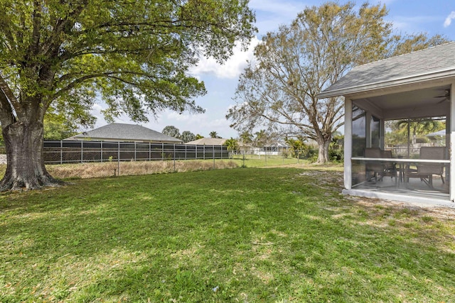 view of yard featuring a sunroom, a patio area, and fence