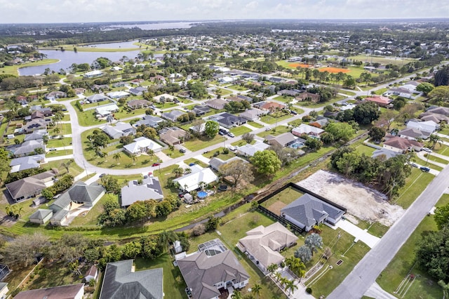 drone / aerial view featuring a residential view and a water view