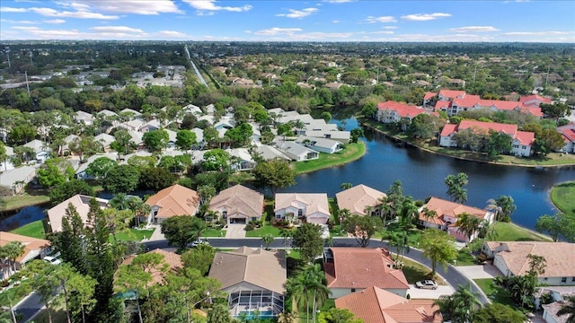 birds eye view of property with a water view and a residential view