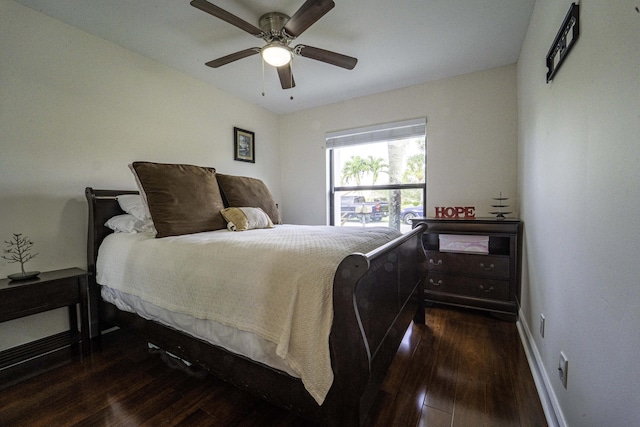 bedroom with dark wood-style floors, baseboards, and a ceiling fan