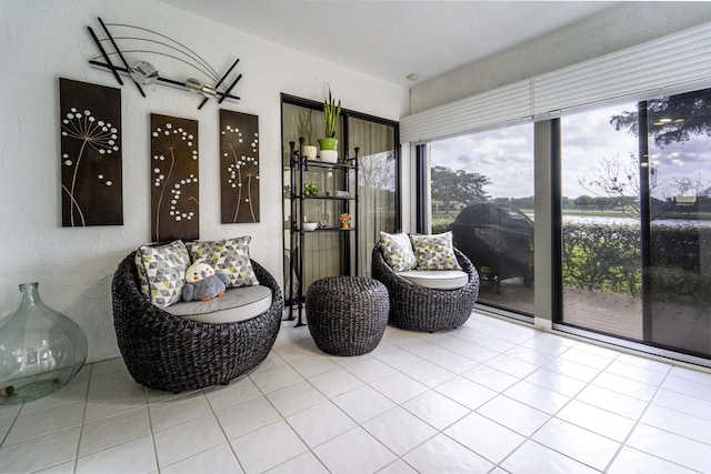 living area featuring a sunroom and light tile patterned flooring