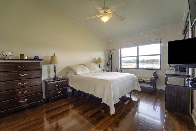 bedroom featuring lofted ceiling, ceiling fan, dark wood-type flooring, baseboards, and crown molding