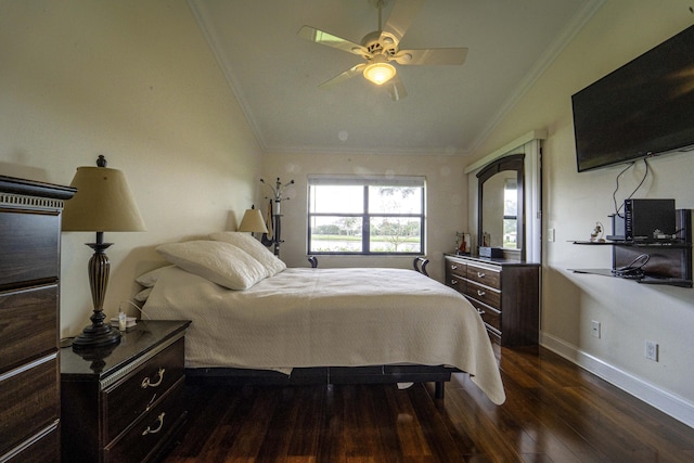 bedroom featuring ornamental molding, lofted ceiling, dark wood-type flooring, and baseboards