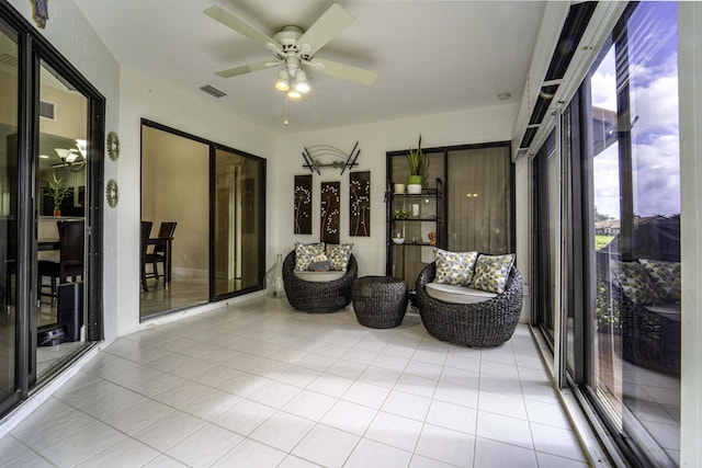 sunroom featuring visible vents and a ceiling fan