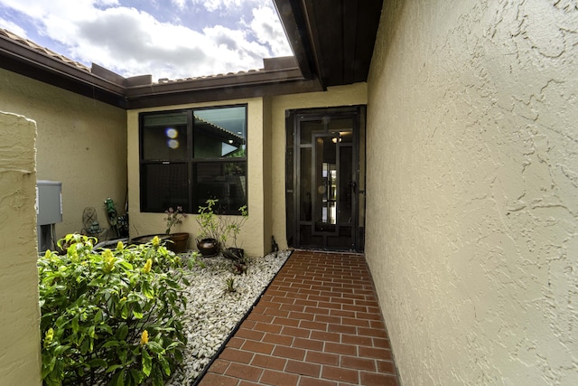 property entrance with stucco siding