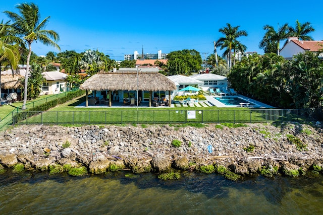 back of property with a patio area, a water view, a community pool, and a gazebo
