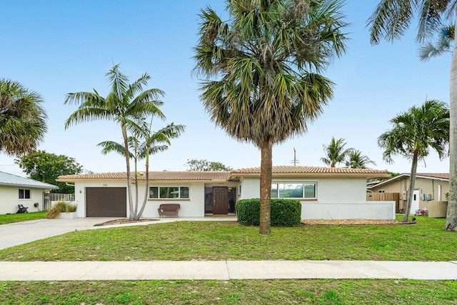 single story home featuring an attached garage, a front lawn, concrete driveway, and stucco siding