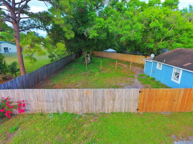 view of yard with a fenced backyard