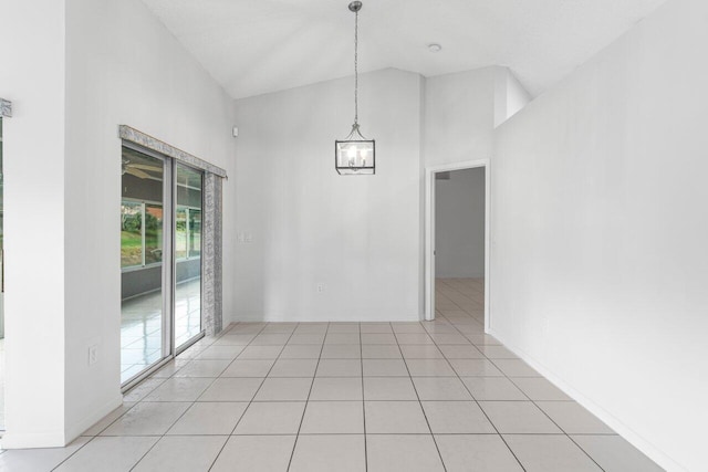 unfurnished dining area featuring light tile patterned floors, baseboards, high vaulted ceiling, and a chandelier