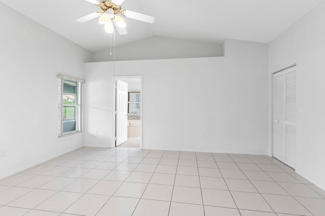 unfurnished room featuring vaulted ceiling, ceiling fan, and light tile patterned floors