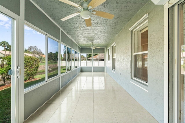 unfurnished sunroom with a ceiling fan