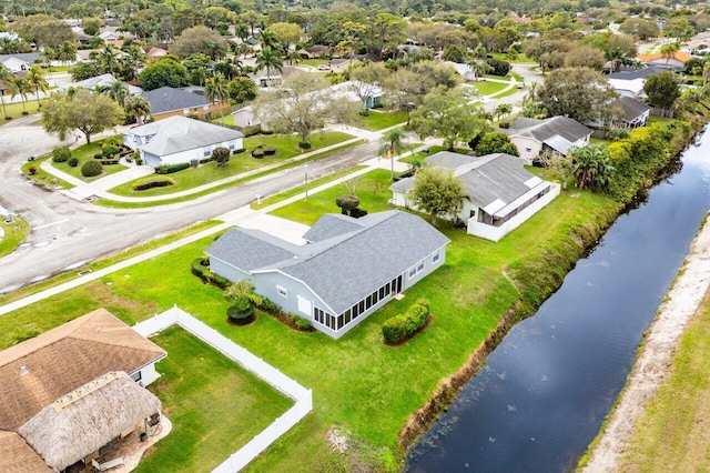 birds eye view of property featuring a water view and a residential view