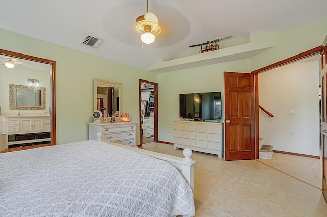 bedroom with visible vents, vaulted ceiling, baseboards, and light tile patterned floors