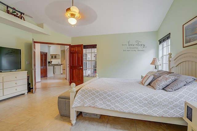 bedroom featuring a ceiling fan, lofted ceiling, and light tile patterned floors