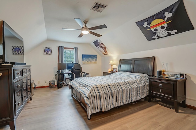 bedroom featuring light wood finished floors, lofted ceiling, visible vents, ceiling fan, and baseboards