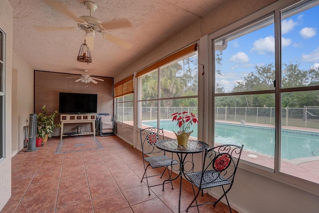 sunroom featuring a ceiling fan