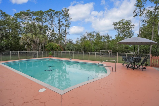 view of swimming pool featuring a patio area, fence, and a fenced in pool