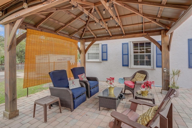 view of patio with an outdoor living space and a gazebo