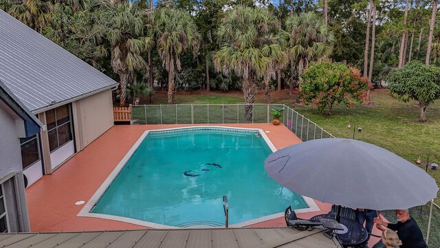 view of swimming pool with a fenced in pool, fence, and a lawn