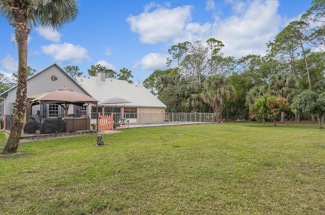 view of yard with a fenced in pool, fence, and a gazebo