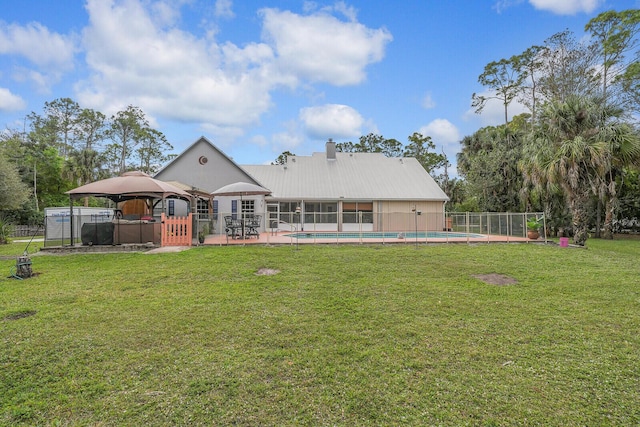 back of house featuring a fenced in pool, fence, a lawn, and a gazebo