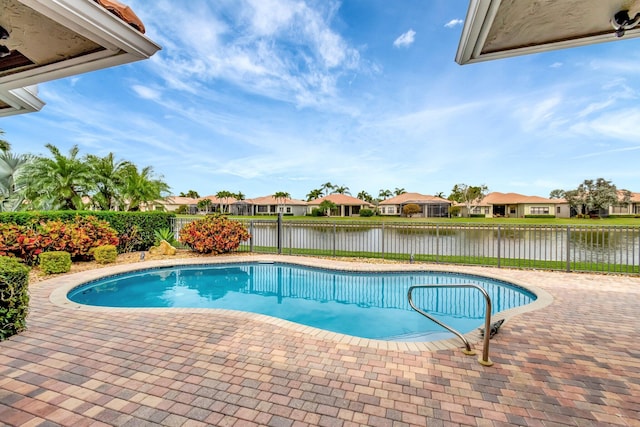 view of swimming pool with a patio, a fenced backyard, a water view, a residential view, and a fenced in pool