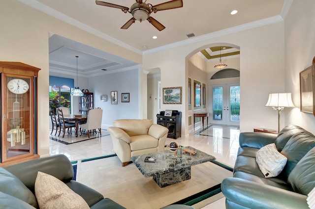 living room with arched walkways, french doors, a tray ceiling, recessed lighting, and ornamental molding