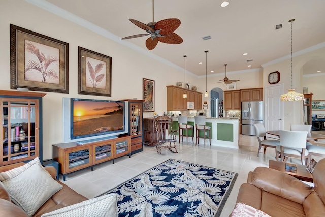 living room with ceiling fan, ornamental molding, and visible vents