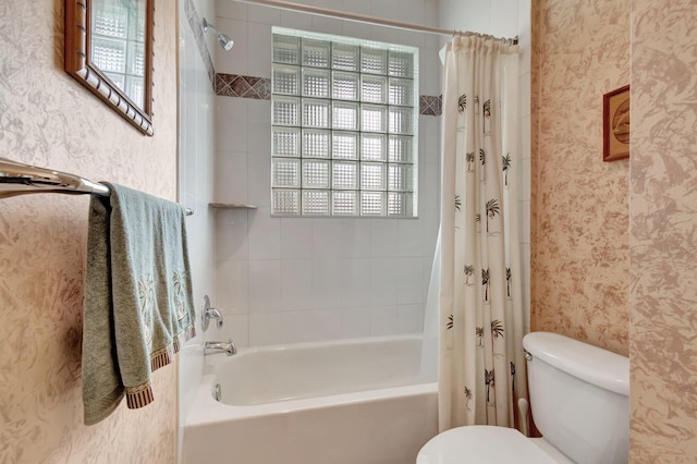 bathroom featuring shower / bath combination with curtain, toilet, and wallpapered walls