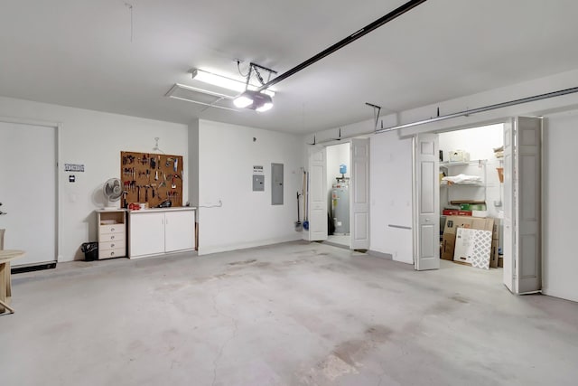 garage featuring water heater, electric panel, and a garage door opener