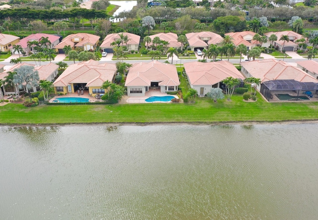 drone / aerial view featuring a water view and a residential view