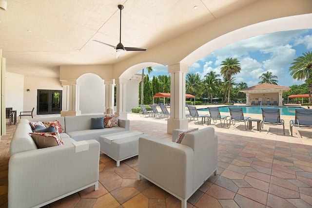 view of patio featuring ceiling fan, outdoor lounge area, and a community pool