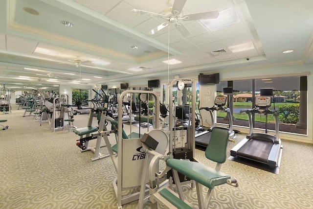 exercise room with ceiling fan, ornamental molding, visible vents, and a healthy amount of sunlight