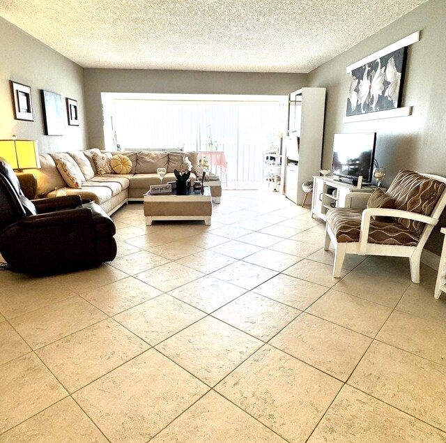 living room featuring tile patterned flooring and a textured ceiling