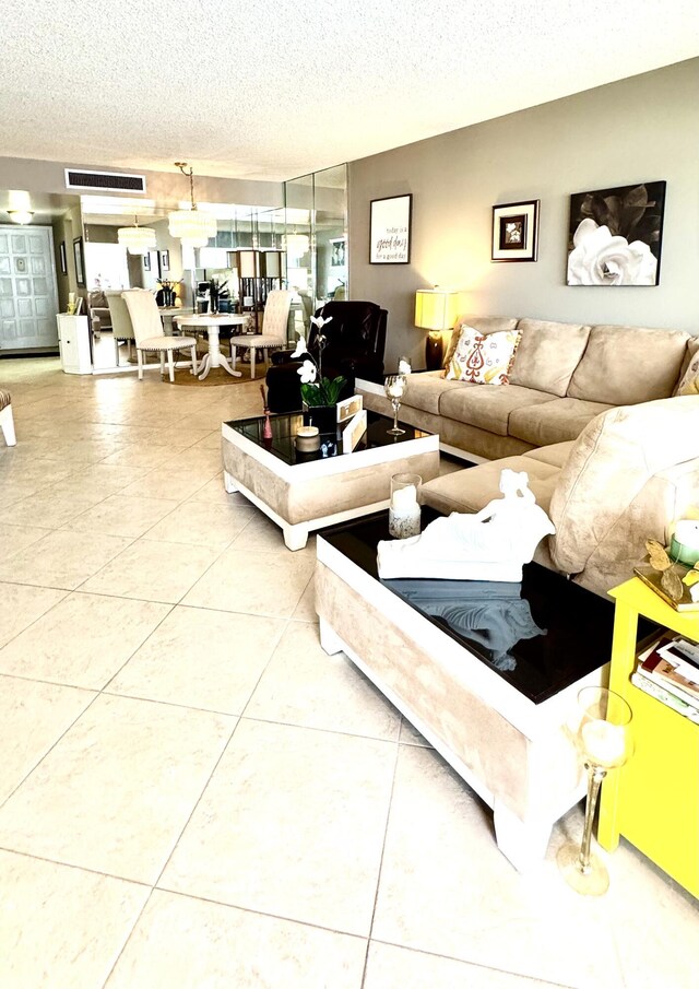 living area featuring a textured ceiling and tile patterned flooring