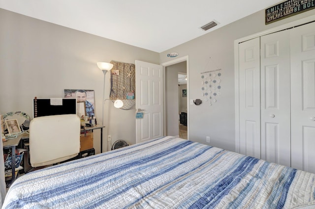 bedroom with a closet and visible vents