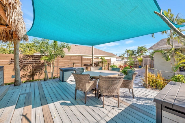 wooden terrace featuring a fenced backyard and outdoor dining space