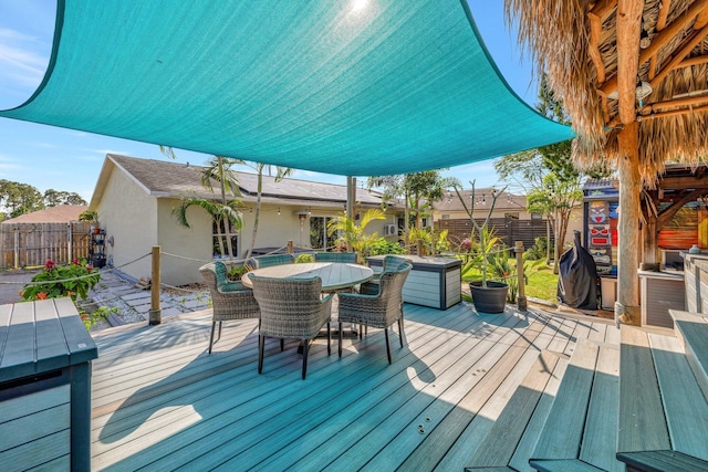 wooden terrace featuring outdoor dining area and fence private yard