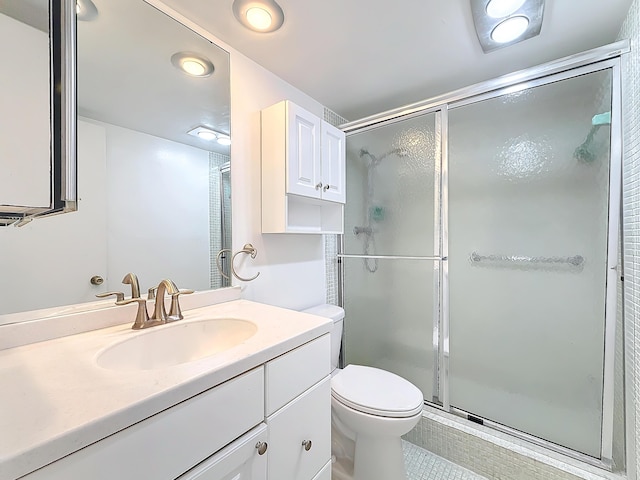 full bathroom with toilet, a shower stall, and vanity