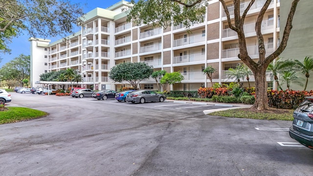 view of building exterior with uncovered parking