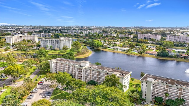 birds eye view of property with a water view and a view of city