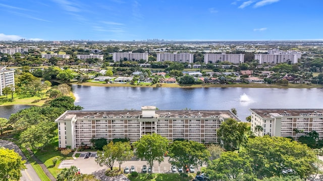 birds eye view of property featuring a view of city and a water view