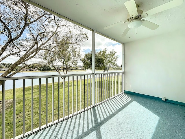 exterior space with a water view and a ceiling fan