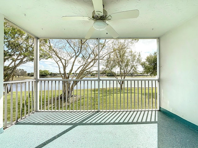 balcony featuring a water view and a ceiling fan