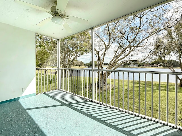 balcony with a water view and ceiling fan