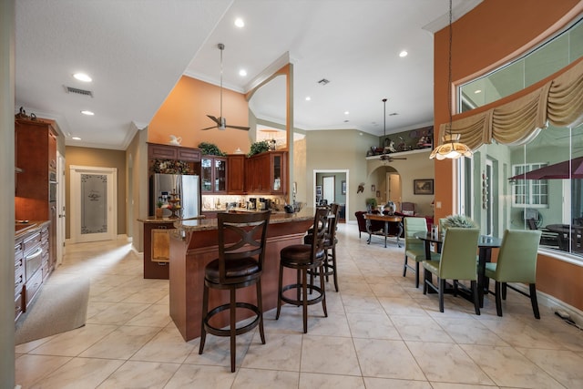 kitchen featuring stainless steel fridge with ice dispenser, glass insert cabinets, dark stone countertops, a peninsula, and pendant lighting