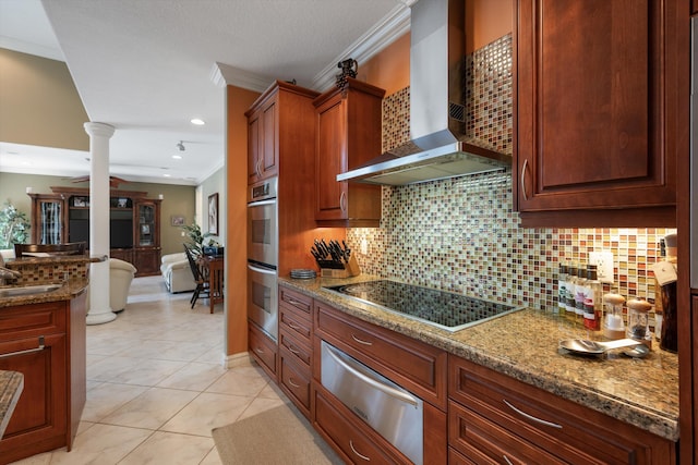 kitchen with ornate columns, light stone countertops, black electric cooktop, wall chimney range hood, and a warming drawer